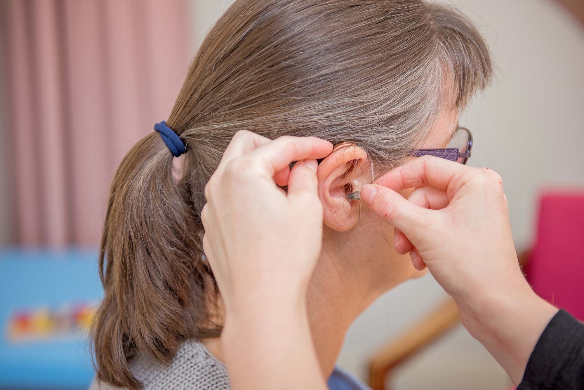 A Woman Having a Hearing Aid Fitting