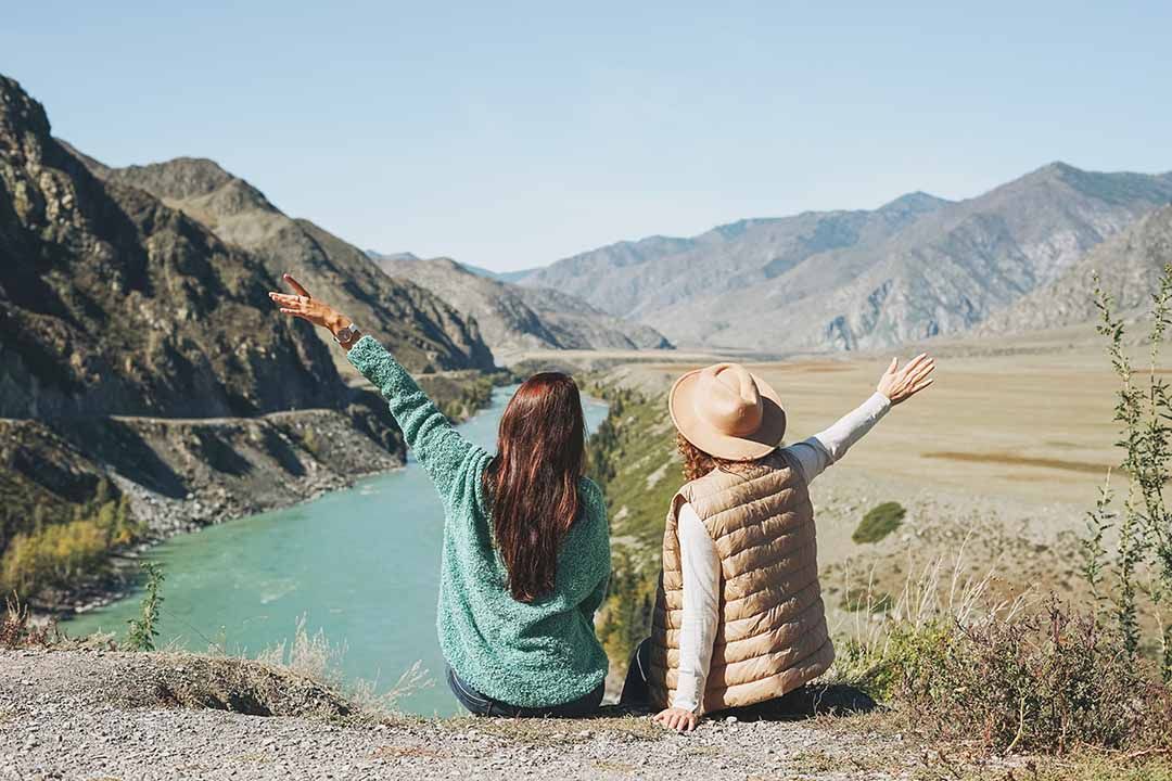 Two Friends Enjoying an Amazing View of Mountains