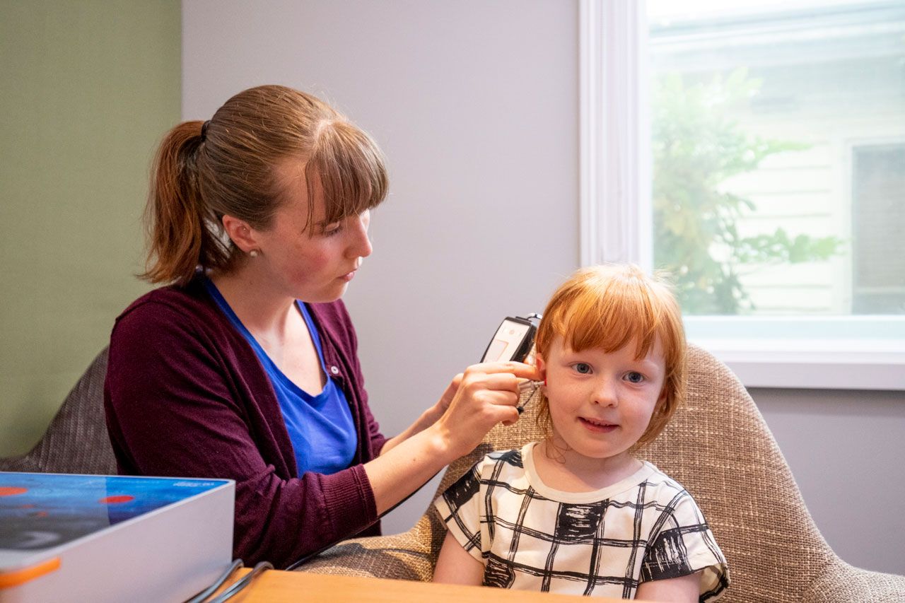  An Audiologist Checking the Ear Health of a Young Girl